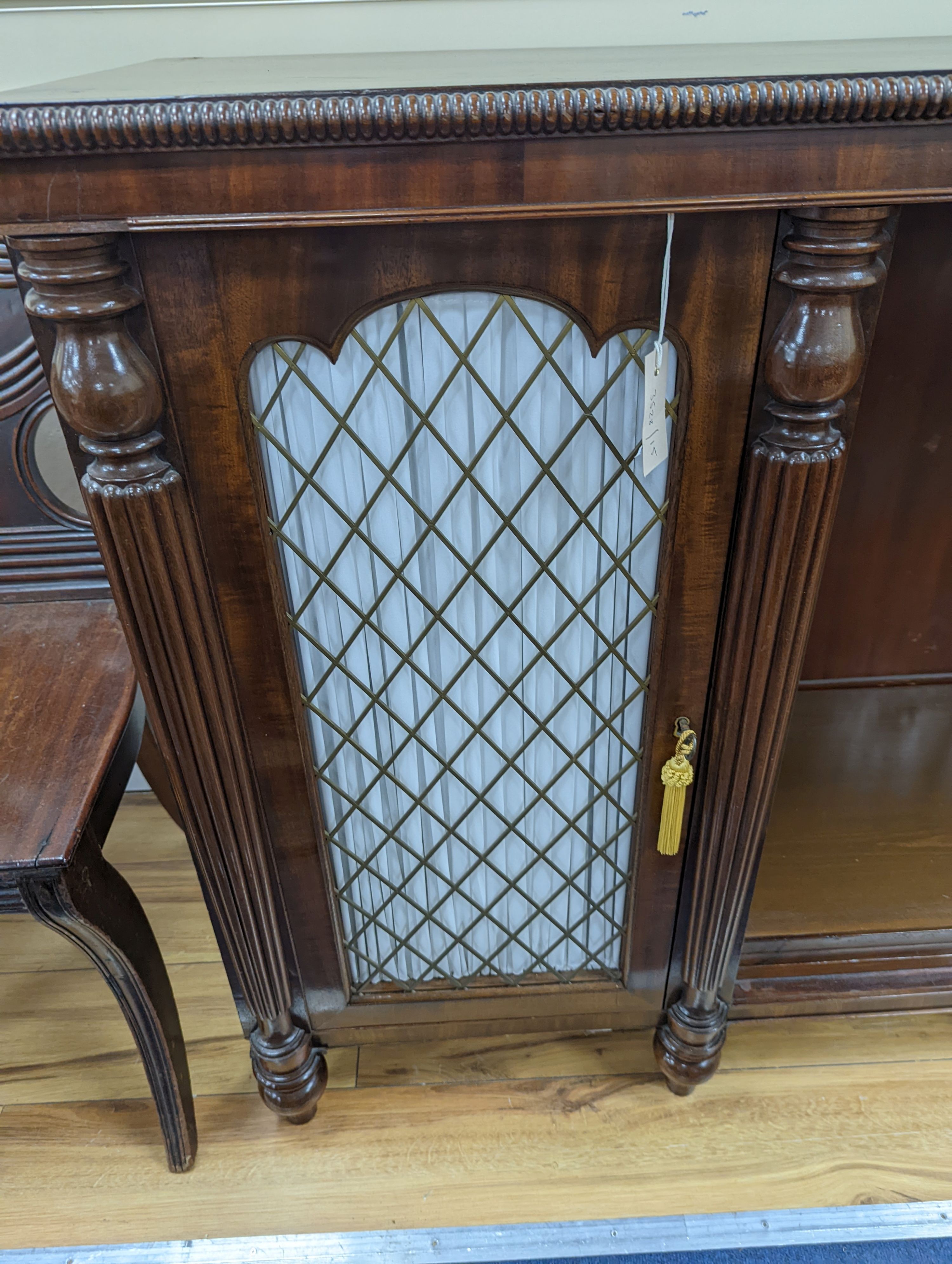 A Regency style mahogany two door dwarf cabinet, width 186cm, depth 45cm, height 91cm